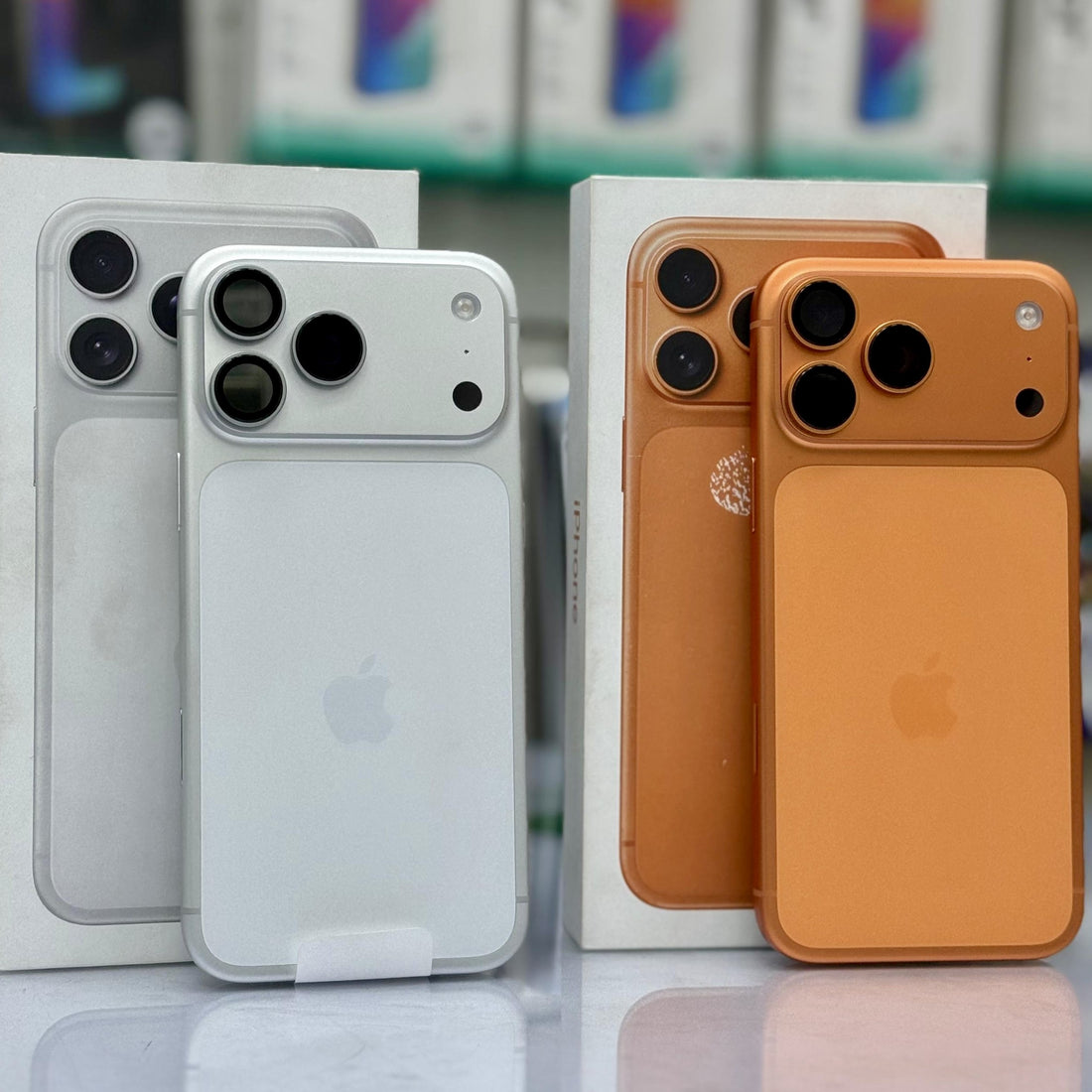 An orange phone back skin or decal applied to a smartphone, shown in front of its white retail box. The skin covers the camera cutouts and back panel, with the Apple logo visible through a slight cutout.