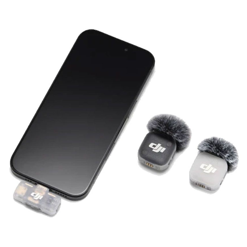 A smartphone shown with two DJI-branded mini microphones attached near the bottom, photographed on a clean white background.